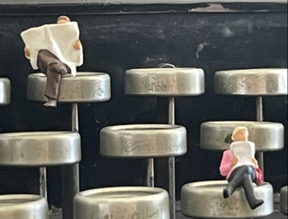 Figuren sitzen auf Schreibmaschinentasten